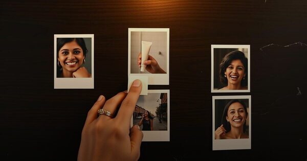 A hand sliding one instant photo print forward from a spread of ad stills